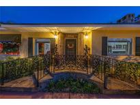 Inviting front entrance featuring decorative iron railings, stone walkway, and elegant lighting at 356 20Th Ne Ave, St Petersburg, FL 33704