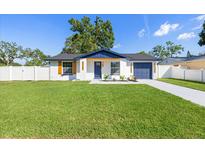 Charming single-story home featuring a well-manicured lawn, fresh exterior paint and inviting curb appeal at 3709 Danny Bryan Blvd, Tampa, FL 33619