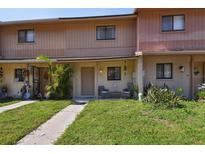 Charming townhouse showcasing a cozy porch and well-maintained front lawn at 4017 Cedar Limb Ct, Tampa, FL 33614