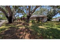 Charming single-story home featuring mature trees and a well-maintained lawn at 4021 19Th N St, St Petersburg, FL 33714