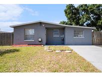 Charming single-story home features a well-maintained front yard and neutral gray exterior at 4521 W North St, Tampa, FL 33614