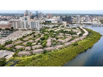 Beautiful aerial view of Island Walk private residences surrounded by lush greenery and waterfront with the city in the background at 612 Arbor Lake Ln, Tampa, FL 33602