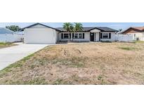 Charming one-story home featuring a modern exterior and two palm trees in the front yard at 7607 22Nd W Ave, Bradenton, FL 34209