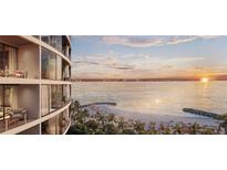 Waterfront condominium building featuring private balconies with beach and ocean views at sunset at 805 S Gulfview Blvd # 602A, Clearwater, FL 33767