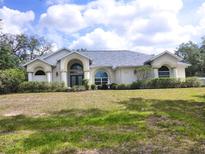 Stunning front exterior showcases a well-manicured lawn, and architectural design at 12271 Centralia Rd, Weeki Wachee, FL 34614
