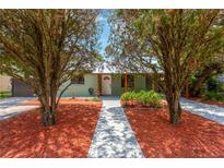 Charming home with a well-manicured front yard and inviting entryway at 2303 E Osborne Ave, Tampa, FL 33610