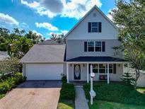 Charming two-story home with a well-maintained front yard, brick driveway, and covered front porch at 2311 64Th Street W Ct, Bradenton, FL 34209