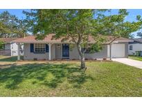 Charming single-story home with a well-manicured front yard and beautiful curb appeal at 2613 E 113Th Ave, Tampa, FL 33612
