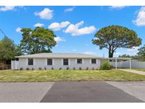 Charming single-story home featuring a well-maintained lawn, carport and beautiful mature trees at 2907 W Tyson Ave, Tampa, FL 33611