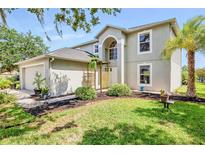 Charming two-story home boasts mature landscaping, a two-car garage, and inviting curb appeal at 31747 Loch Aline Dr, Wesley Chapel, FL 33545