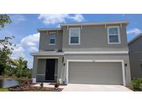 Inviting two-story home featuring a two-car garage and well-maintained landscaping at 3446 Suncoast Plains Dr, Odessa, FL 33556