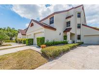 Charming townhouse with manicured landscaping and a private garage, bathed in natural light at 3455 Countryside Blvd # 101, Clearwater, FL 33761