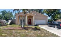 Charming single-Gathering home featuring a well-kept yard, attached garage, and inviting entryway with red door at 3680 19Th S Ave, St Petersburg, FL 33711