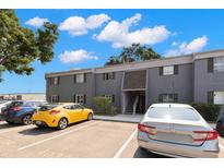 Well-maintained, gray two-story condo with ample parking spaces available for residents and visitors at 4032 Cortez Dr # A, Tampa, FL 33614