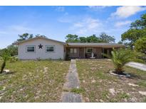 Charming single-story home with a classic facade and a well-maintained front yard at 4499 Collins Rd, Spring Hill, FL 34606