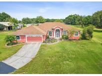 Charming single-story home boasting an attached garage and lush lawn at 5100 Lockhart Rd, Brooksville, FL 34602