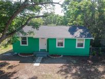 Charming green home with a well-manicured lawn and a welcoming entrance at 5510 12Th St, Zephyrhills, FL 33542