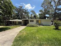 Quaint single story home featuring a well-maintained yard and a covered entrance at 708 Keeling St, Brooksville, FL 34601