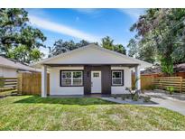Charming single-story home with a well-manicured lawn, complemented by a newly painted exterior at 8603 N 9Th St, Tampa, FL 33604