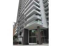 Upscale high-rise building featuring large windows and glass-railed balconies for each unit at 100 1St N Ave # 702, St Petersburg, FL 33701