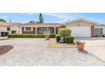 Charming single-story home featuring a brick facade, white trim, and a well-maintained landscaped yard at 10400 112Th Way, Largo, FL 33778
