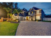 Stunning two-story home with a beautifully landscaped front yard, a circular driveway, and a two car garage at 1229 Hillandale Reserve Dr, Tampa, FL 33613