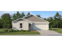Charming single-story home with a two-car garage and beautifully landscaped front yard at 14974 Topaz Blue St, Wimauma, FL 33598