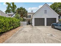 Two-story home featuring a two-car garage and a fenced, landscaped front yard at 16076 Dawnview Dr, Tampa, FL 33624