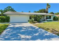 Charming one-story home with a two-car garage, mature landscaping, and a beautiful, tiled roof at 1775 62Nd S Ter, St Petersburg, FL 33712