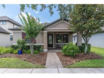 Charming single-story home with manicured landscaping and a welcoming front porch at 3095 Riders Pass, Odessa, FL 33556