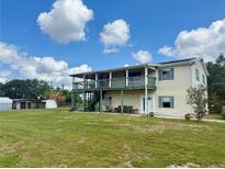 Charming home with a large porch, showcasing its inviting curb appeal and outdoor space at 439 Corbett Rd, Lithia, FL 33547