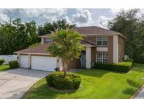 Charming two-story home featuring a well-manicured lawn and an attached two-car garage at 4750 Augusta Ave, Oldsmar, FL 34677