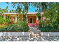 Charming single-story home with well-manicured landscaping and inviting front porch at 506 S Melville Ave, Tampa, FL 33606