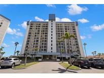 Beautiful building with lush landscaping, well-maintained grounds, and ample parking at 9415 Blind Pass Rd # 1201, St Pete Beach, FL 33706
