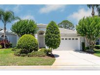 Charming single-story home featuring a well-manicured lawn and a two-car garage at 1130 Hominy Hill Dr, Trinity, FL 34655