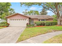 Charming single-story home with well-manicured lawn and landscaping at 1880 Oak Bark Ct, Clearwater, FL 33763