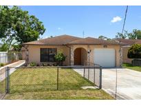 Charming single-story home with a stone facade, well-maintained lawn, and inviting curb appeal at 4208 W Flora St, Tampa, FL 33614
