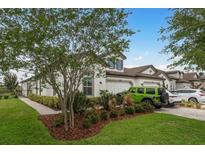 Beautiful home with a well-manicured lawn, lush landscaping, and a three-car garage at 4583 Barletta Ct, Wesley Chapel, FL 33543