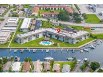 Waterfront condo features a pool, boat dock, and beautiful community landscaping at 5157 Silent Loop # 208, New Port Richey, FL 34652