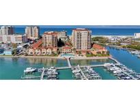 Stunning aerial view of beachfront condos, boat docks and azure waters at 521 Mandalay Ave # 307, Clearwater Beach, FL 33767