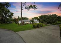 Charming single-story home with a well-manicured lawn and mature trees, offering great curb appeal at 5933 Carina Trce, Wesley Chapel, FL 33545