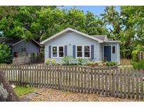Charming single-story home with light-blue siding and a rustic wood fence at 6489 30Th N St, St Petersburg, FL 33702