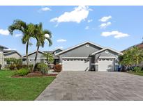 Charming single-story home with well-maintained landscaping, and a spacious driveway leading to a two-car garage at 6611 Surfside Blvd, Apollo Beach, FL 33572