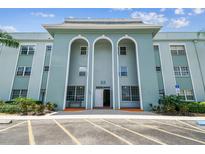 Attractive building exterior featuring arched entryways and convenient parking at 701 Poinsettia Rd # 340, Belleair, FL 33756