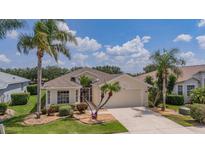 Inviting one-story home featuring lush landscaping, decorative plants, and a spacious driveway at 8223 Haven Harbour Way, Bradenton, FL 34212