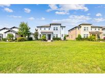 Two story home on a manicured lawn surrounded by green grass under a sunny sky at 17589 Cruiser Bnd, Land O Lakes, FL 34638