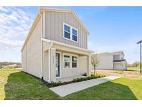 Charming two-story home with gray siding, a cozy front porch, and a well-manicured lawn at 2039 Amelia Bay Pl, Valrico, FL 33596
