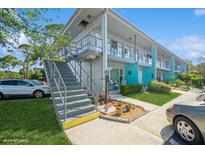 Charming two-story condominium building featuring easy access stairs and colorful accents at 4325 58Th N Way # 1527, Kenneth City, FL 33709
