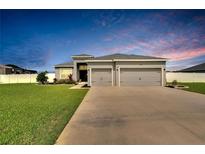 Charming single-Gathering home with a well-manicured lawn and a two-car garage at 4435 Devinshire Fields Loop, Plant City, FL 33567