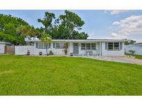 Charming single-story home featuring a manicured lawn, freshly painted exterior, and delightful curb appeal at 513 Fairhope Dr, Apollo Beach, FL 33572